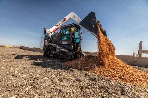 A Bobcat T76 Platinum Package Compact Track Loader Dumps Dirt From its Bucket