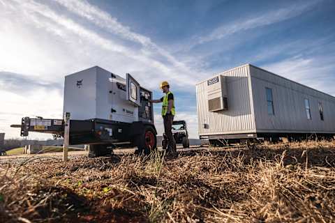 A Worker Operates a Bobcat Portable Generator