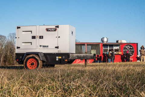 A Bobcat Portable Generator Parked Near a Food Trailer