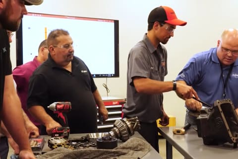 Randy Riesland overseeing other Bobcat service technicians during a training session at a Colorado Bobcat training facility.