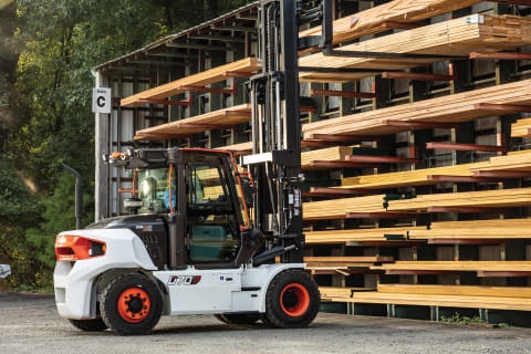 Side View of the Bobcat D70S-9 Forklift Grabbing Wood From a Shelf at an Outdoor Lumberyard