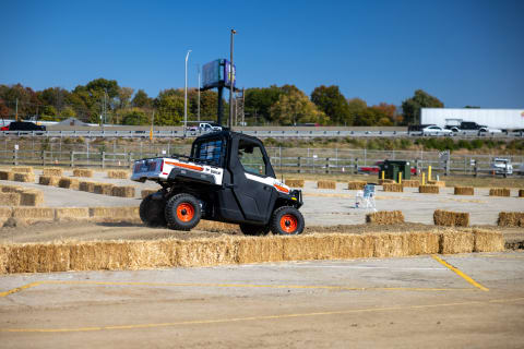 An operator drives a Bobcat UTV at the test track during Equip Expo 2022.