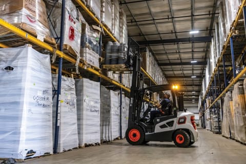 An Operator Grabs a Pallet of Materials From a High Shelf Using the Bobcat D25S-9 Forklift