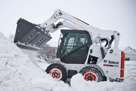 Bobcat S570 Skid Steer Loader hauling snow