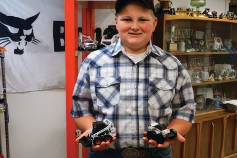 Jake Heshelman holding toy Bobcat Machines