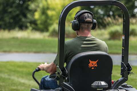 A Rear View of an Operator Mowing With a ZT5000 Zero-Turn Mower