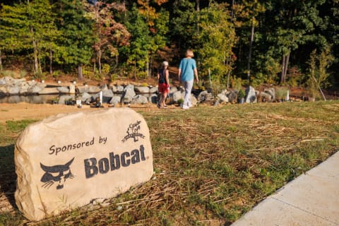 A large rock engraved with “Sponsored by Bobcat” sits at the Davidson County Parks and Recreation Yadkin River Park site as part of the Bobcat and National Recreation and Park Association grant.