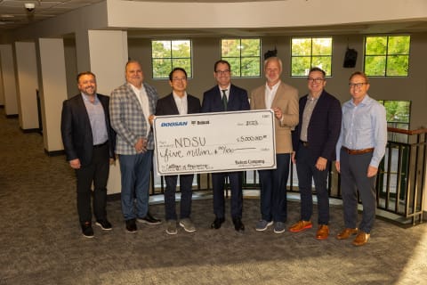 Bobcat and NDSU representatives hold an oversized check for $5 million to signify Bobcat’s donation to NDSU’s College of Engineering. 