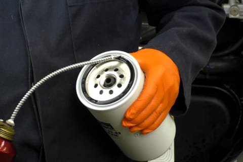 Technician applies a thin layer of clean oil on the filter O-rings.