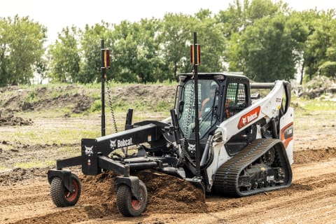 Operator Uses a Bobcat T86 Compact Track Loader With a Grader Attachment to Level Gravel