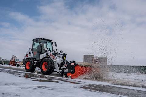 Bobcat L95 Compact Wheel Loader Clears Snow With Angle Broom Attachment