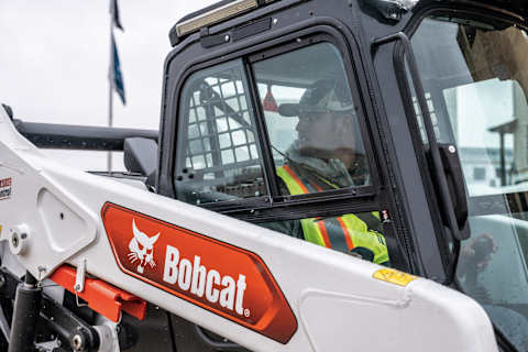 An Operator Backs Up a Bobcat T86 Compact Track Loader