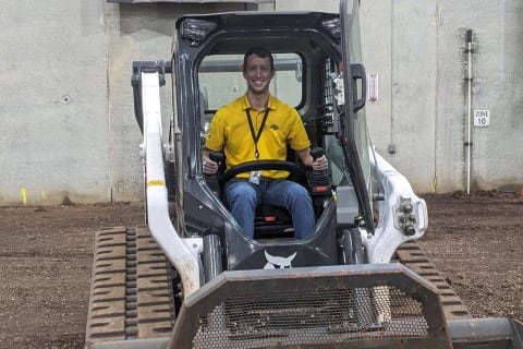 Drew Asche operating Bobcat compact track loader.