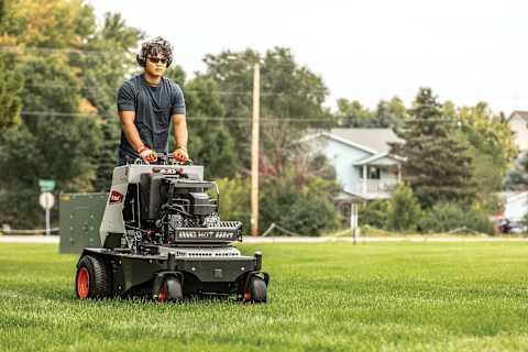Operator Using a Bobcat AE30s to Aerate a Large Lot