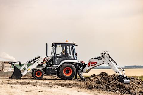 A Bobcat Backhoe Loader Digging Dirt