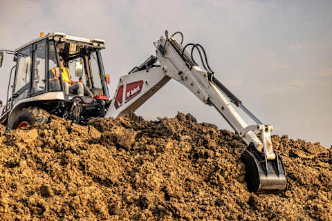 A Bobcat B760 Scoops Dirt