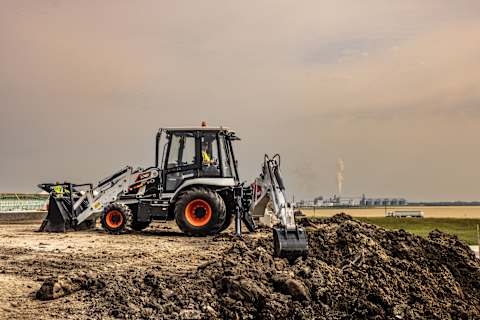 A Bobcat B760 Backhoe Loader Digging Dirt