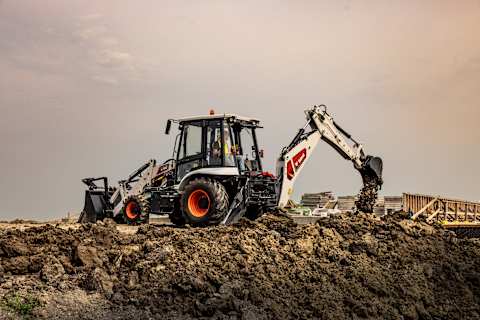 A Bobcat B760 Backhoe Loader to Digs and Dumps Dirt