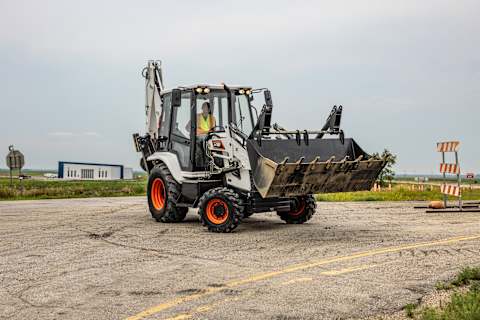 A Bobcat B760 Travels Across a Gravel-Covered Jobsite