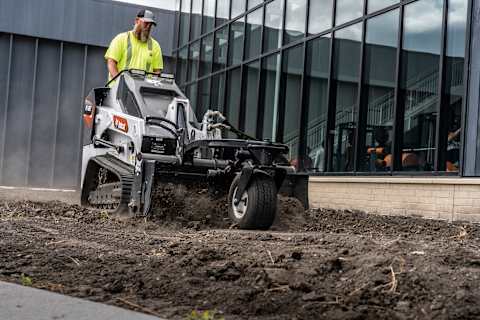 Bobcat MT120 operating a soil conditioner attachment on turf