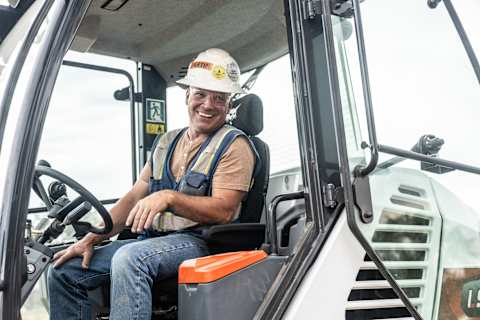 Operator Eric Niemann Sits Inside the Cab of a Bobcat Compact Wheel Loader at a Jobsite