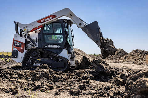A Bobcat T66 Compact Track Loader Dumps Dirt on a Worksite Using Its Bucket
