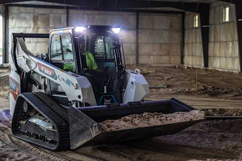 Bobcat T7X All-Electric Compact Track Loader Carries Dirt in Bucket 