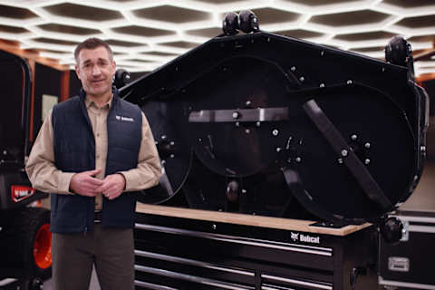 The Bobcat Advantage zero-turn mowers host Jim standing next to the AirFX Deck, which is positioned on the table to showcase the innovative design.