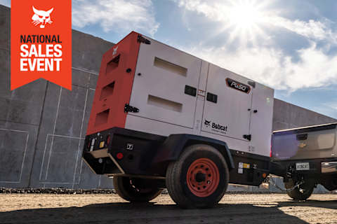 A Bobcat PG50 Portable Generator Being Towed Behind a Pickup Truck With the National Sales Event Badge