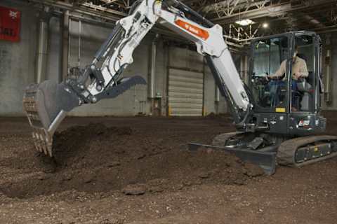 An Operator Opens the Clamp on a Bobcat Compact Excavator Bucket