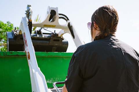 Bobcat MT120 operator, Julie Holland, showcasing lift height