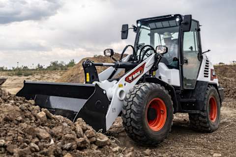 A Bobcat L95 Compact Wheel Loader With A Bucket Is Used to Move Debris