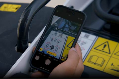 Smartphone with Quick Response (QR) Code for a Bobcat Training Video on the Screen