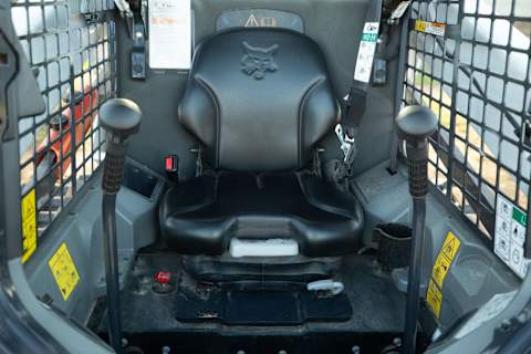 Interior of T595 Bobcat loader cab with standard hand controls