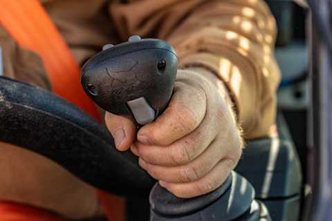 Bobcat Pro T66-2 Compact Track Loader Operator Gripping the Joystick Control Inside the Cab