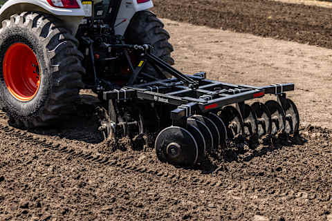 Compact Tractor Using 78 in. 3pt. Disc Harrow Implement.