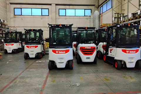 Fleet of Bobcat electric and diesel forklifts parked inside a warehouse at the Port of Gioia Tauro