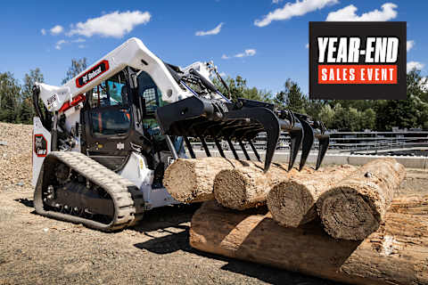Bobcat Pro T66-2 Compact Track Loader With Industrial Grapple Attachment Handling Large Logs at an Outdoor Worksite With a Year-End Sales Event Badge