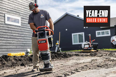 Operador de apisonadora Bobcat R60P compactando tierra en una obra residencial con gráfico de evento de ventas de fin de año.