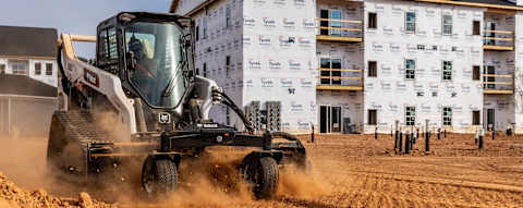 An Operator Uses a Bobcat Pro T76-2 Compact Track Loader With a Soil Conditioner Attachment at a Residential Construction Site