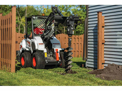 Using The Bobcat L28 Small Articulated Loader With Auger Attachment To Dig A Post Hole.