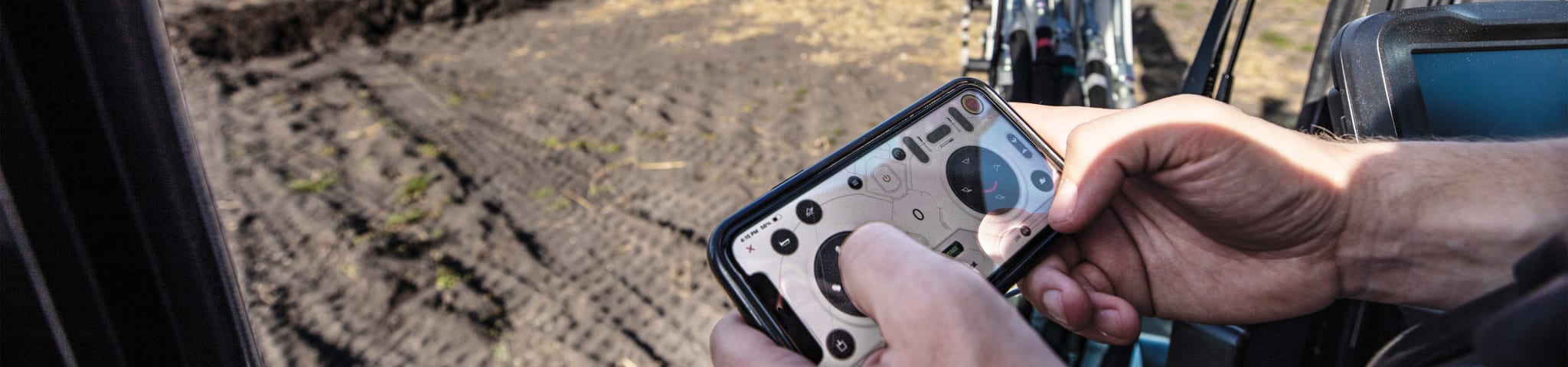 A Bobcat operator using max control to move equipment on a jobsite 