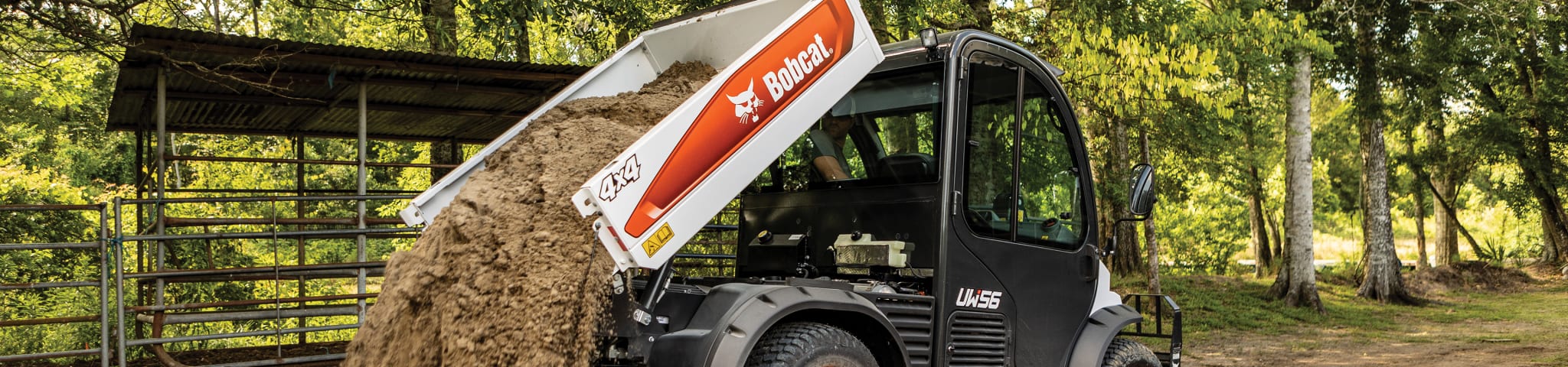 Operator Dumps Dirt From the Cargo Box of a Bobcat Toolcat Utiility Work Machine