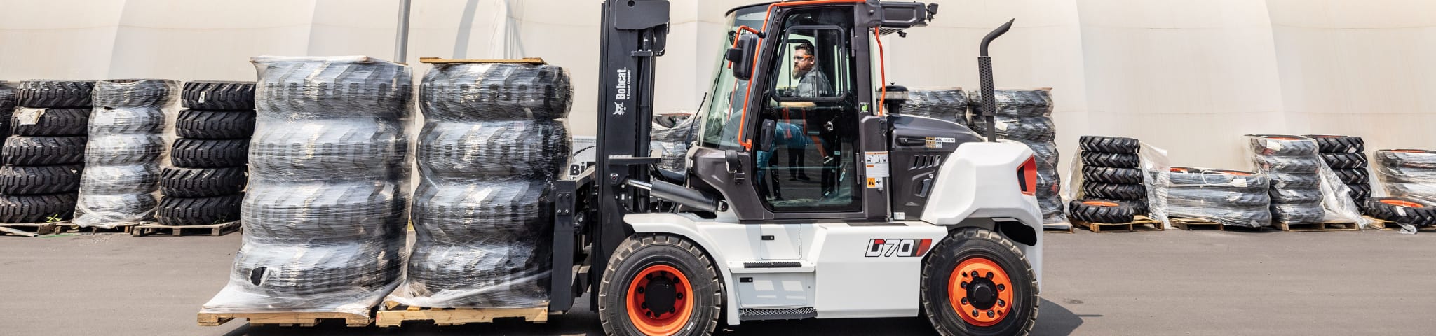 A Bobcat D70S-9 Forklift Carries Pallets of Tires Around a Lot