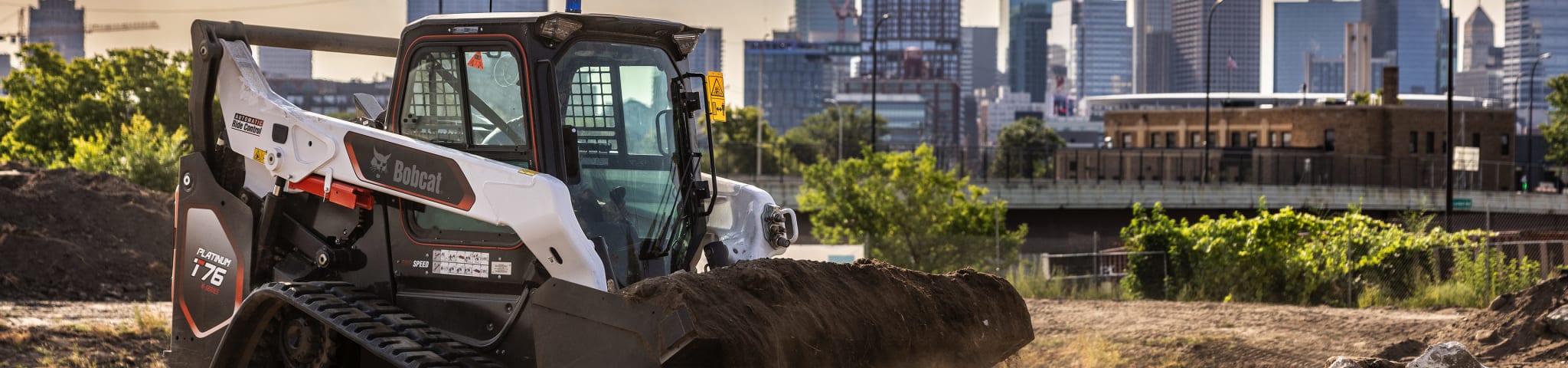 A Bobcat Platinum T76 Compact Track Loader Carries Soil in Its Bucket