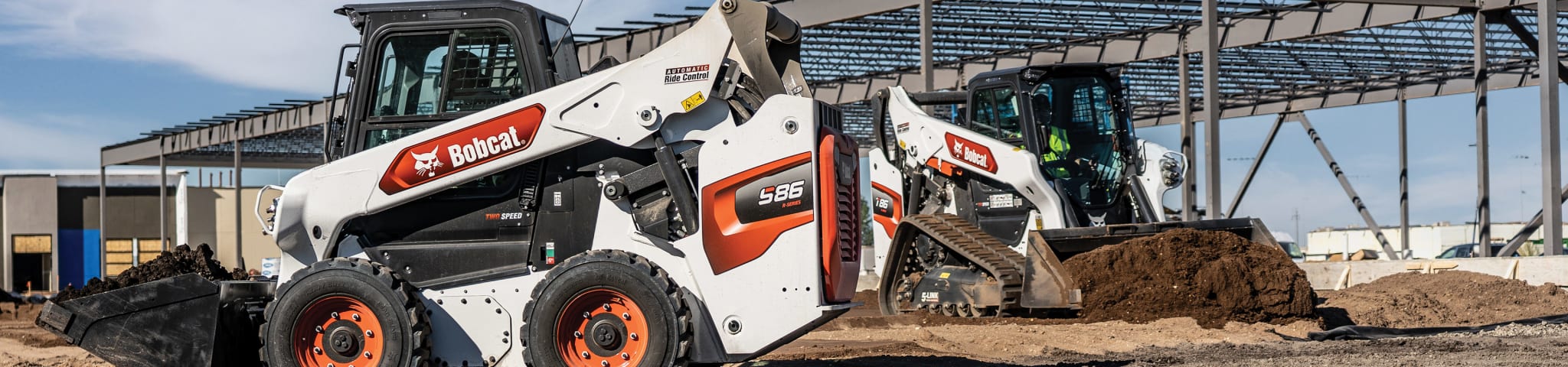 A Bobcat Compact Track Loader and Skid-Steer Loader Work Simultaneously on a Construction Jobsite