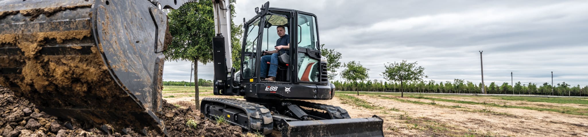 A Close-Up Image of the Bucket on a Bobcat E88 Compact Excavator Scooping Dirt 