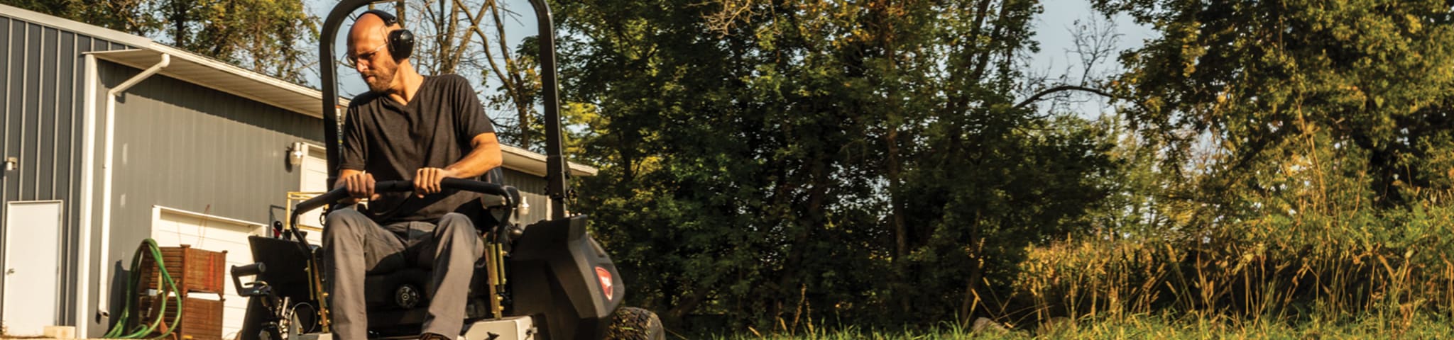 An Operator Uses a Bobcat ZT7000 Zero-Turn Mower to Trim an Overgrown Lawn