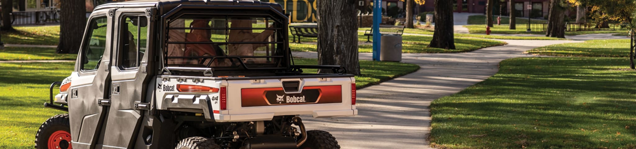 A Bobcat UV34XL Utility Vehicle Drives Through a College Campus