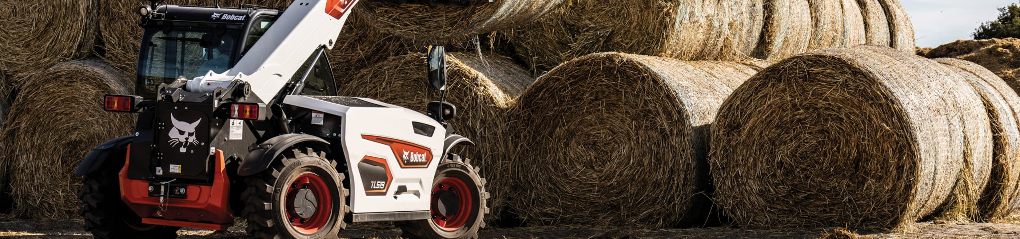 Bobcat TL519 Using Bale Fork to Lift Huge Round Bale